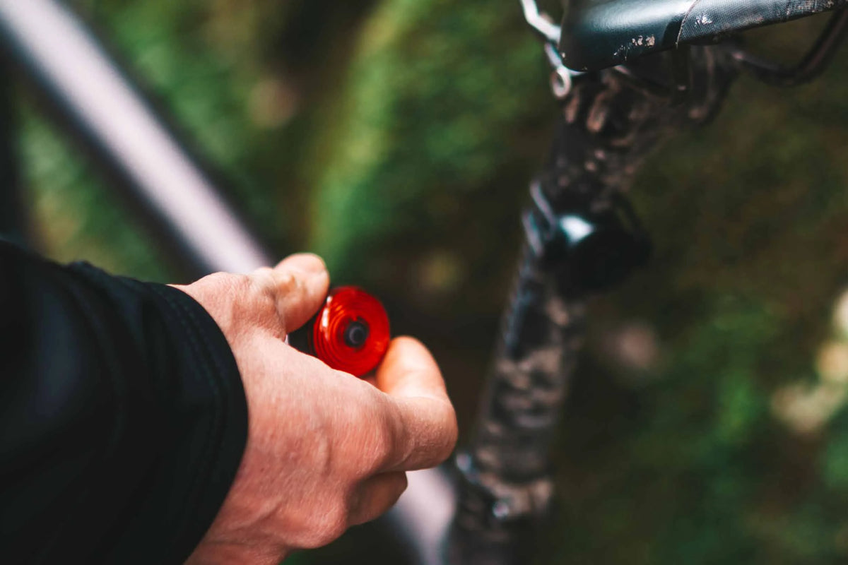 Cyclist using a rear bike tail light during daytime riding