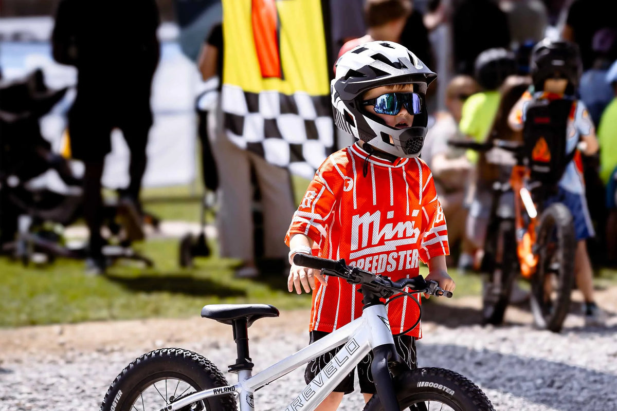 Child wearing a full-face bike helmet while riding outdoors