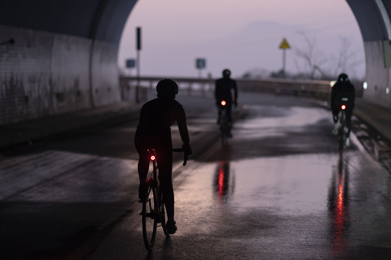 Cyclist practicing safe night riding with lights and reflective gear for visibility