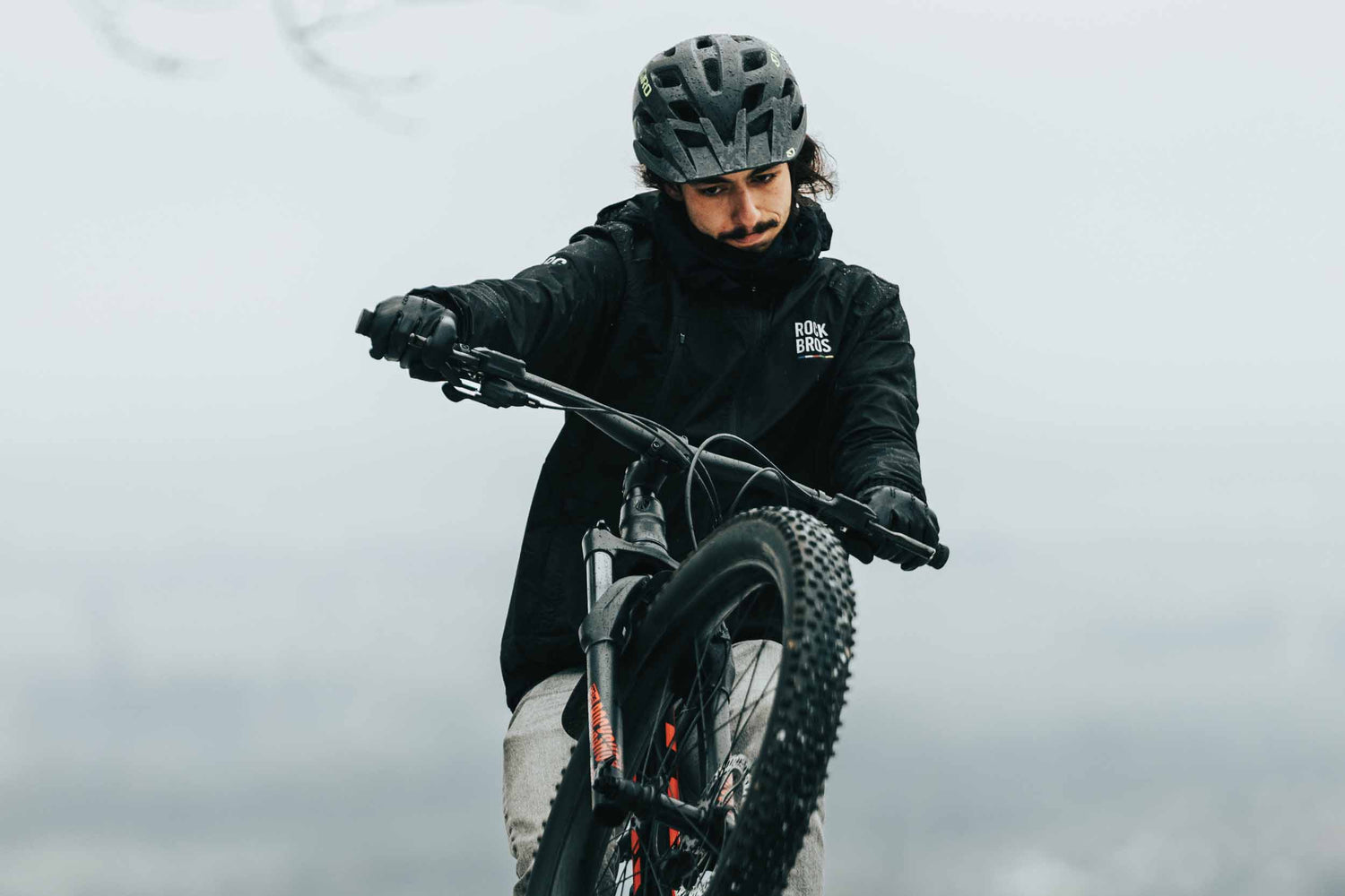 Cyclist wearing breathable thermal layers during a cold morning ride to prevent overheating.