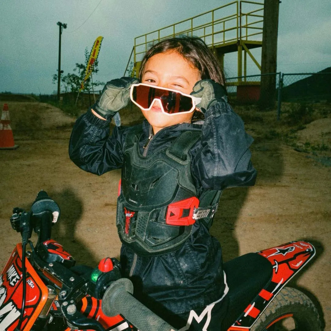 Little cyclist wearing SP383 kids polarized cycling sunglasses for outdoor sports, UV protection eyewear for children.
