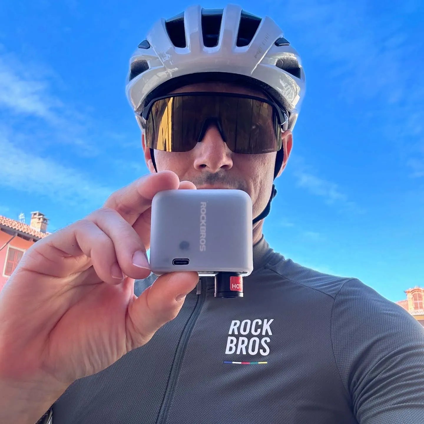 Cyclist using a ROCKBROS portable electric bike pump during a ride