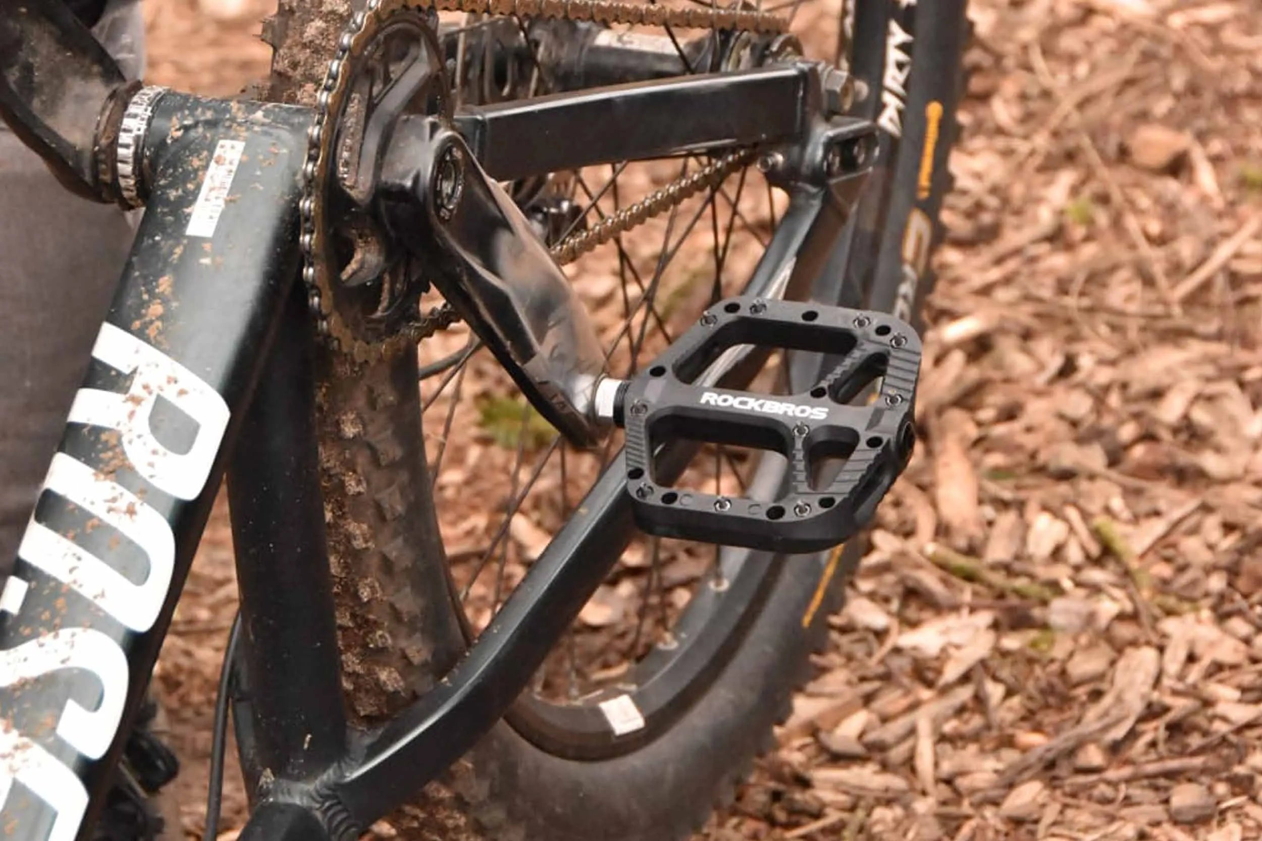 Wide platform flat bike pedals with anti-slip pins for mountain biking and commuting