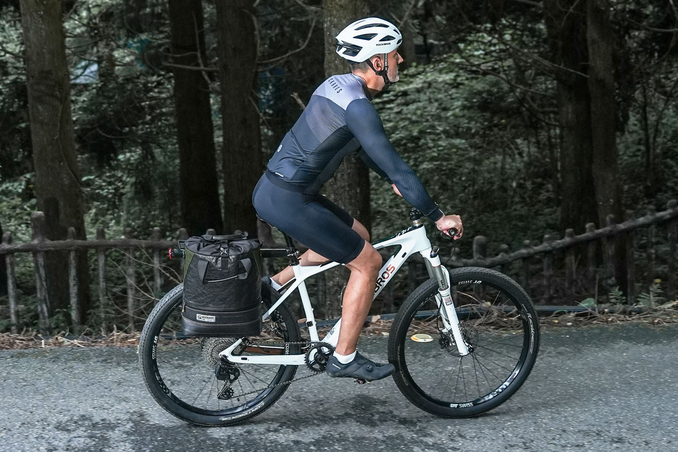 Cyclist riding through nature with ROCKBROS eco bike bags supporting green lifestyle.