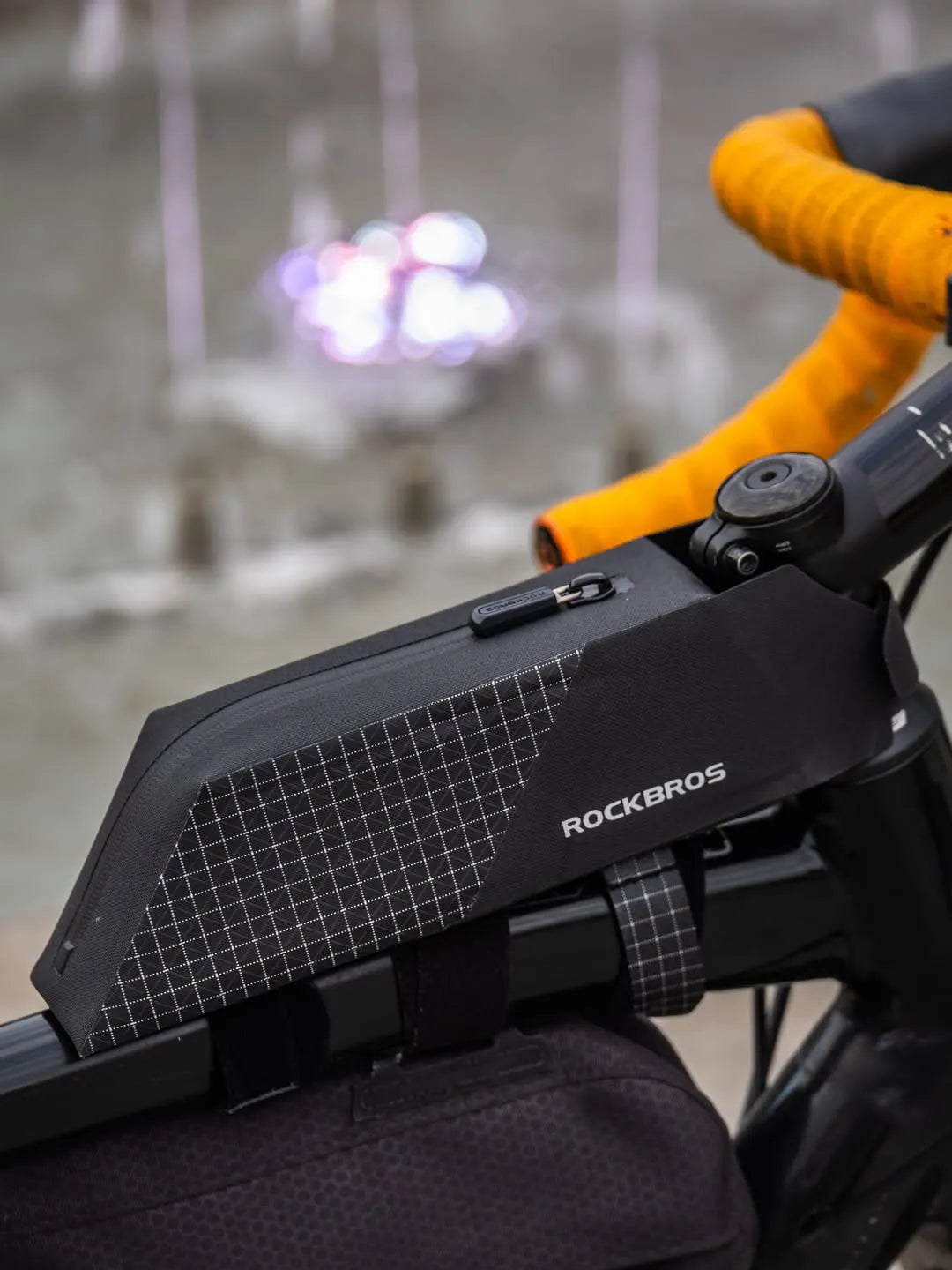 A close-up of a black Rockbros bicycle frame bag mounted on a bike frame