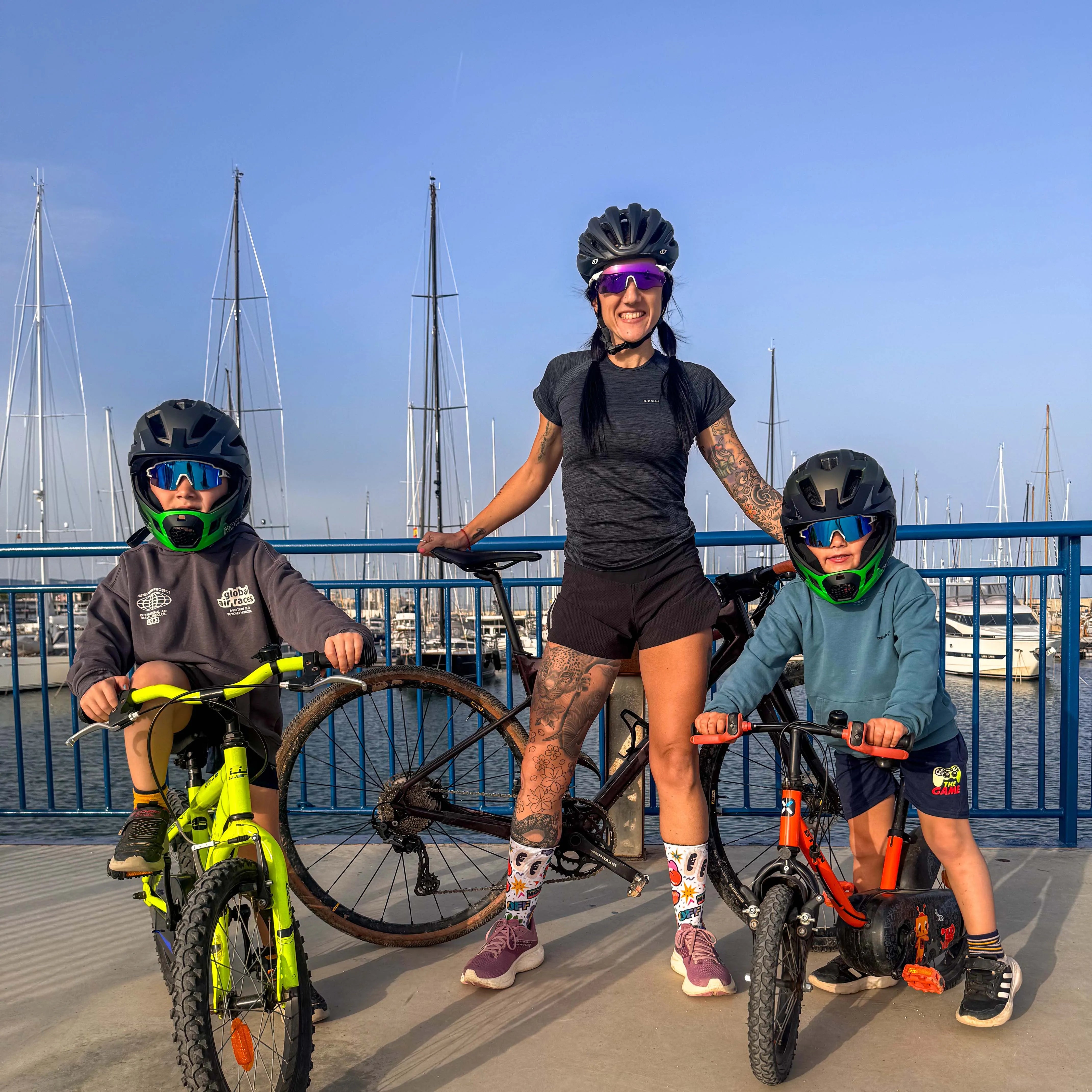 Family enjoying a bike ride together with helmets and cycling gear