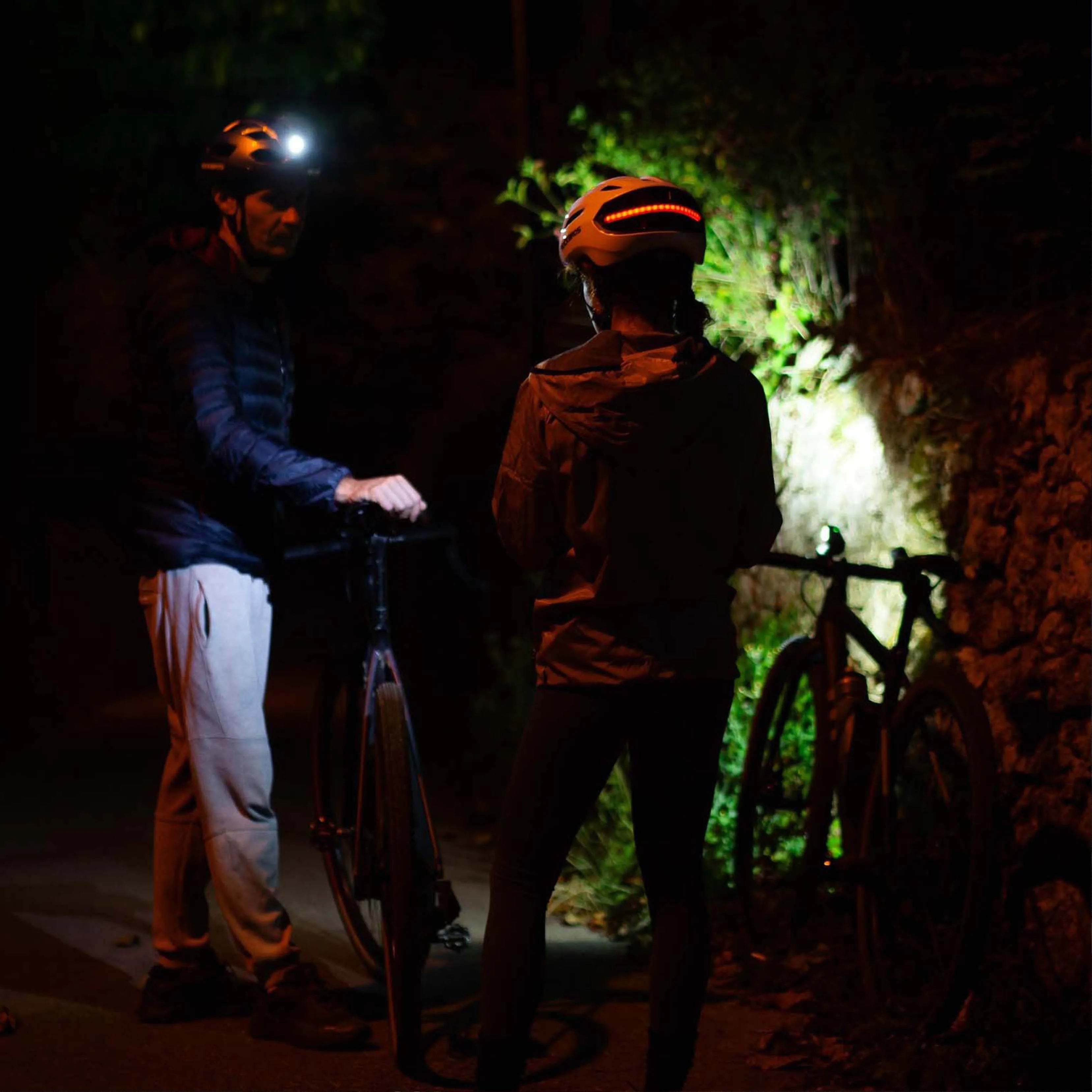 Cyclist using helmet with light for visibility in traffic, moving headlight direction, safer intersections
