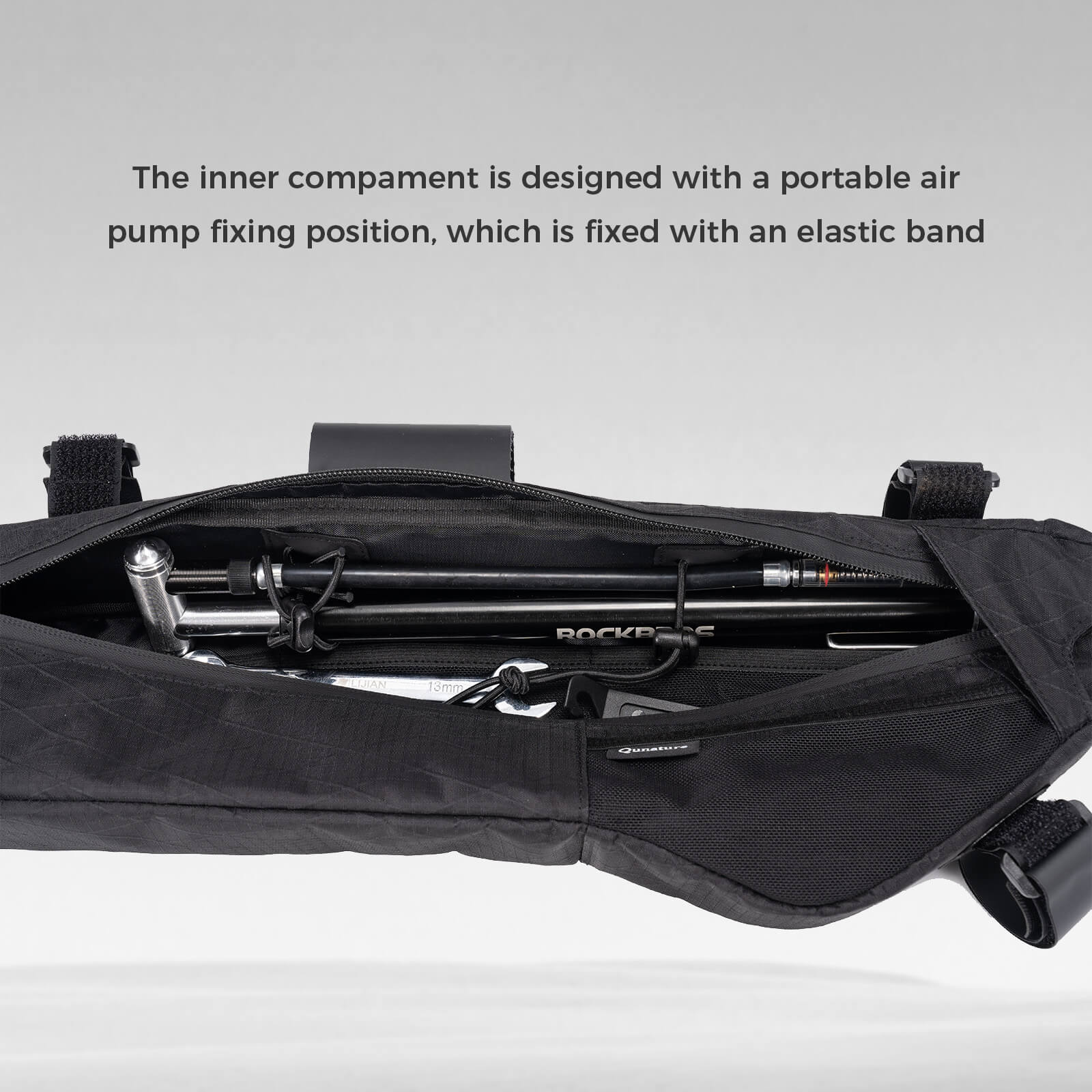 Detail view of the hidden hydration hose port and power cable access on the 5L bike down tube bag.