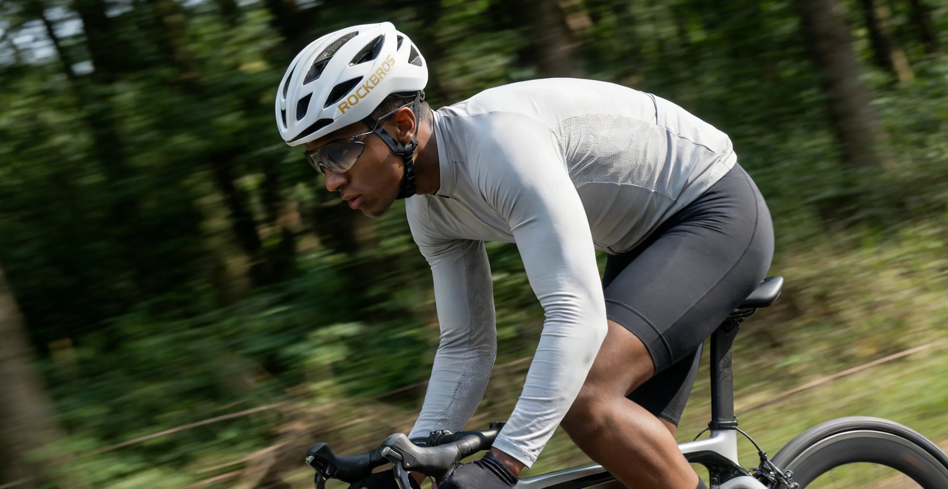 cyclist with helmet and cycling sunglasses riding outdoors during riding season