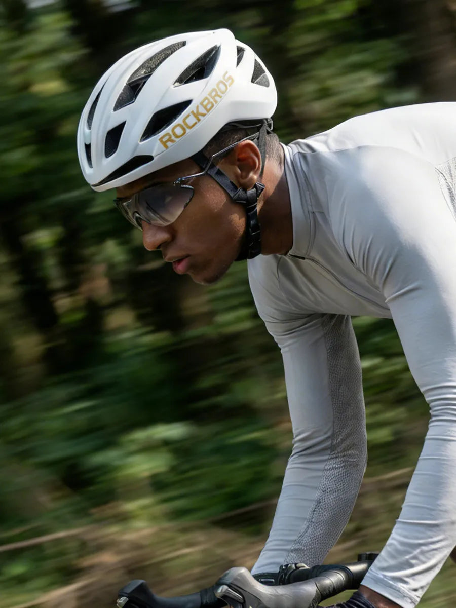 cyclist with helmet and cycling sunglasses riding outdoors during riding season