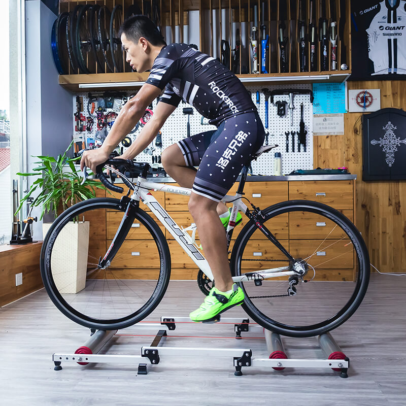 ROCKBROS foldable aluminum roller bike trainer showing both expanded and folded states for compact indoor cycling storage.