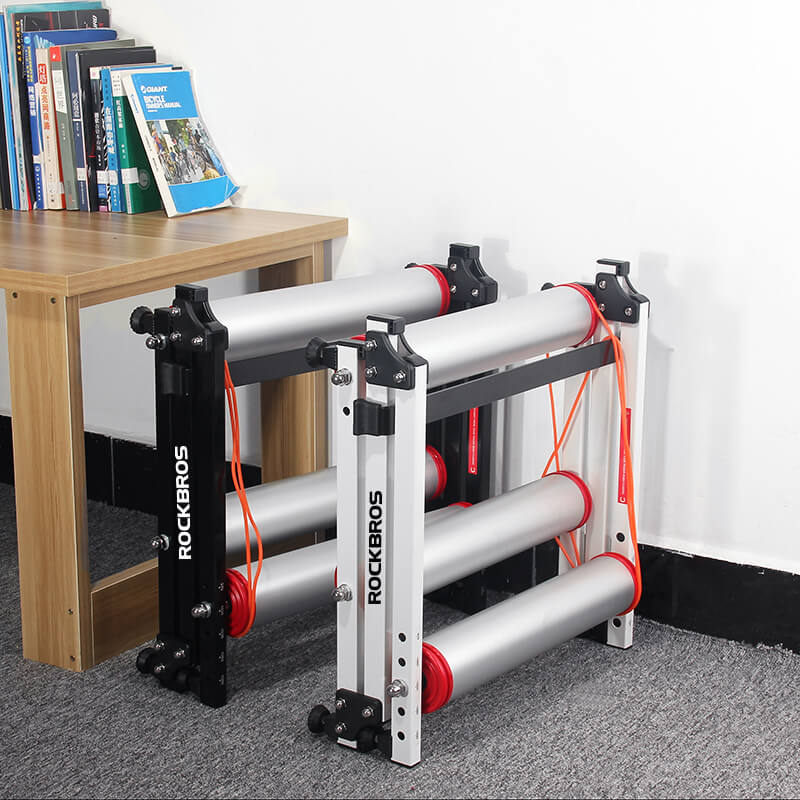 ROCKBROS foldable aluminum roller bike trainer showing both expanded and folded states for compact indoor cycling storage.