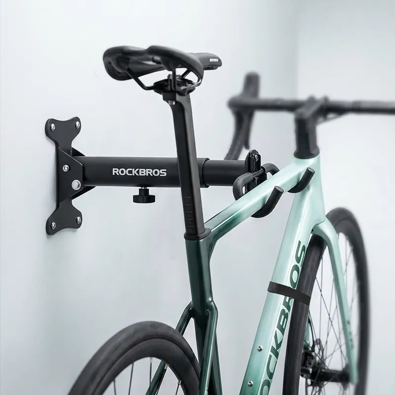 ROCKBROS foldable bike wall rack folded flat against the wall to save storage space