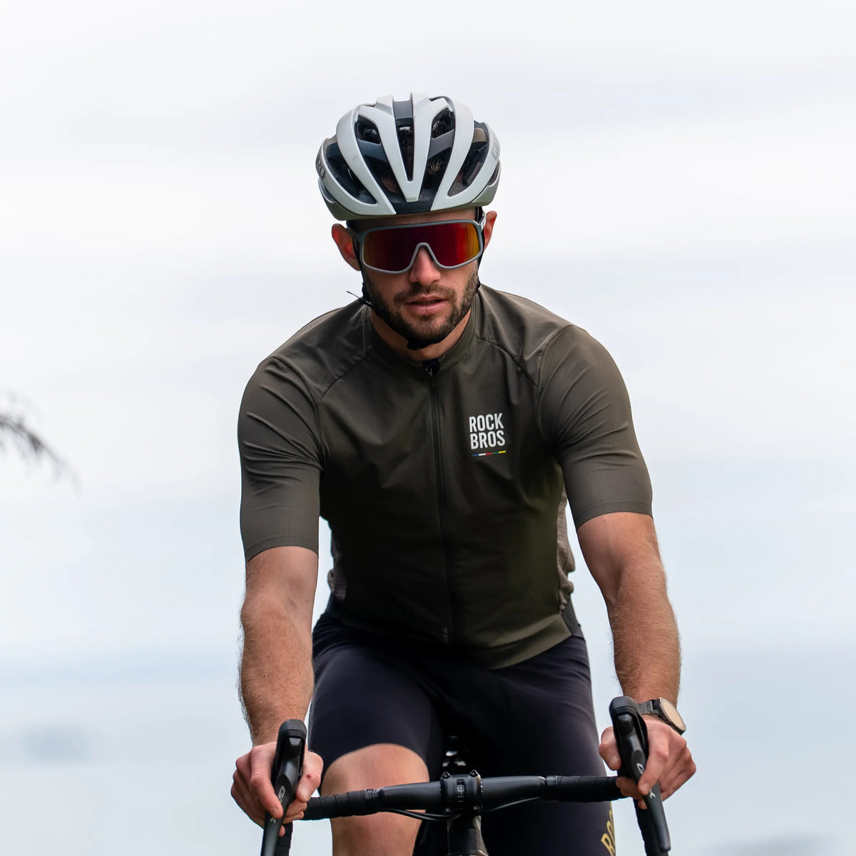 Summer cycling gear including polarized sunglasses and lightweight riding apparel