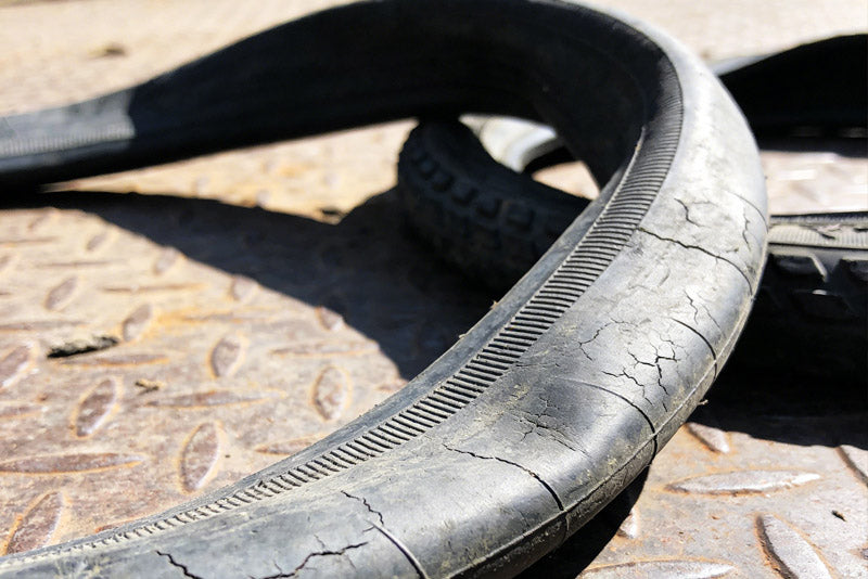 Worn-out tire on a textured surface
