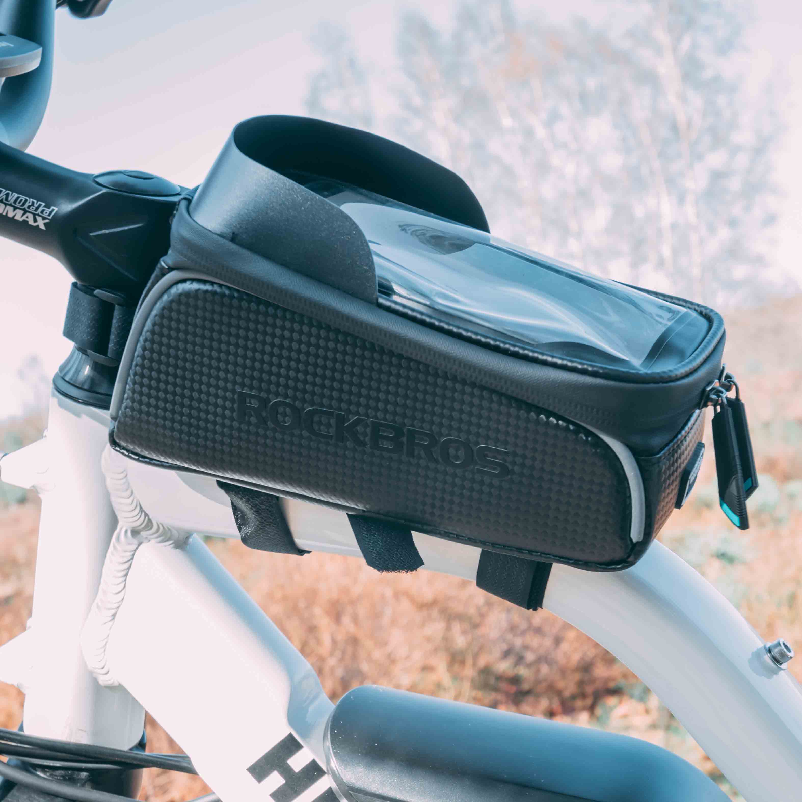 ROCKBROS waterproof bike phone front frame bag with sensitive TPU touchscreen, sun visor, and hardshell design, fits smartphones up to 7.0 inches.