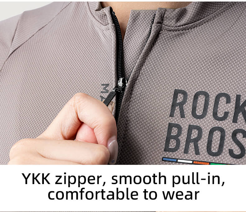 Person wearing a gray hoodie with 'ROCKBROS' branding, focusing on the YKK zipper.